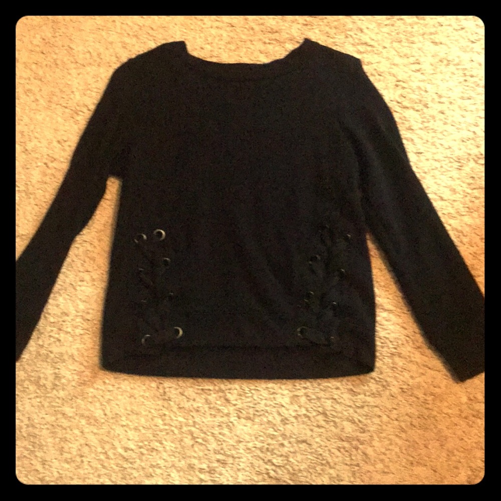 Black sweater with two braids going down